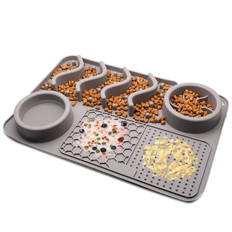 Grey silicone dog slow feeder mat with raised ridges, water bowl, and licking pad compartments