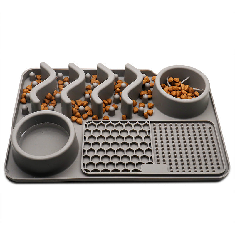 Grey silicone dog slow feeder mat with raised ridges, water bowl, and licking pad compartments