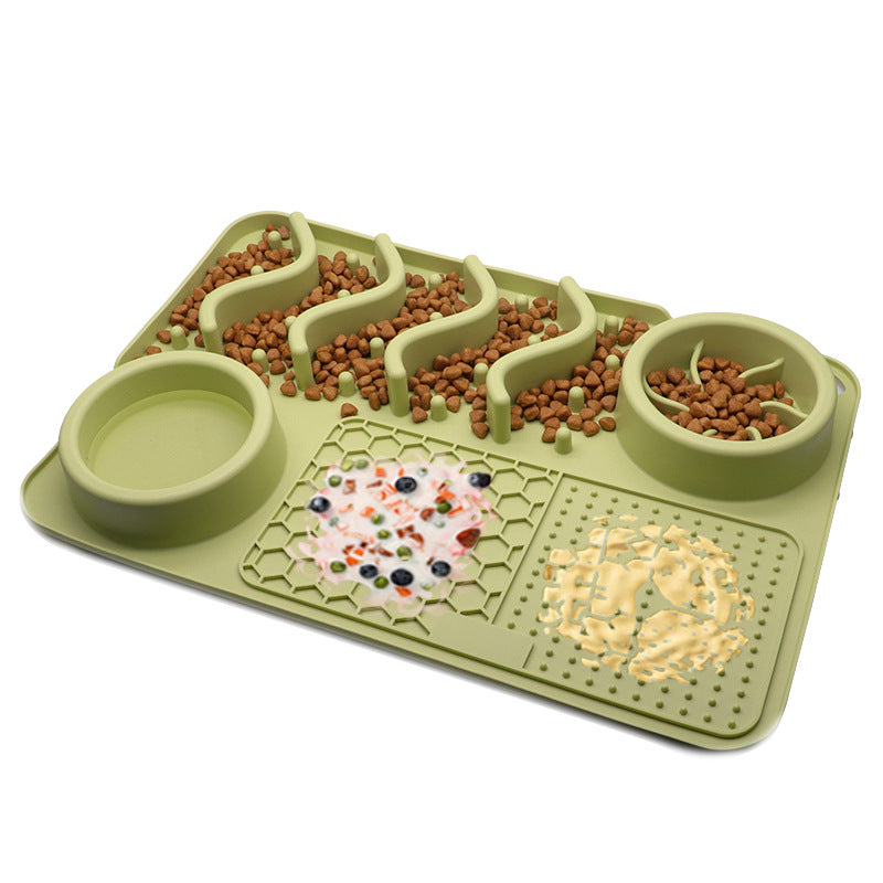 Light green silicone dog slow feeder mat with raised ridges, water bowl, and licking pad compartments