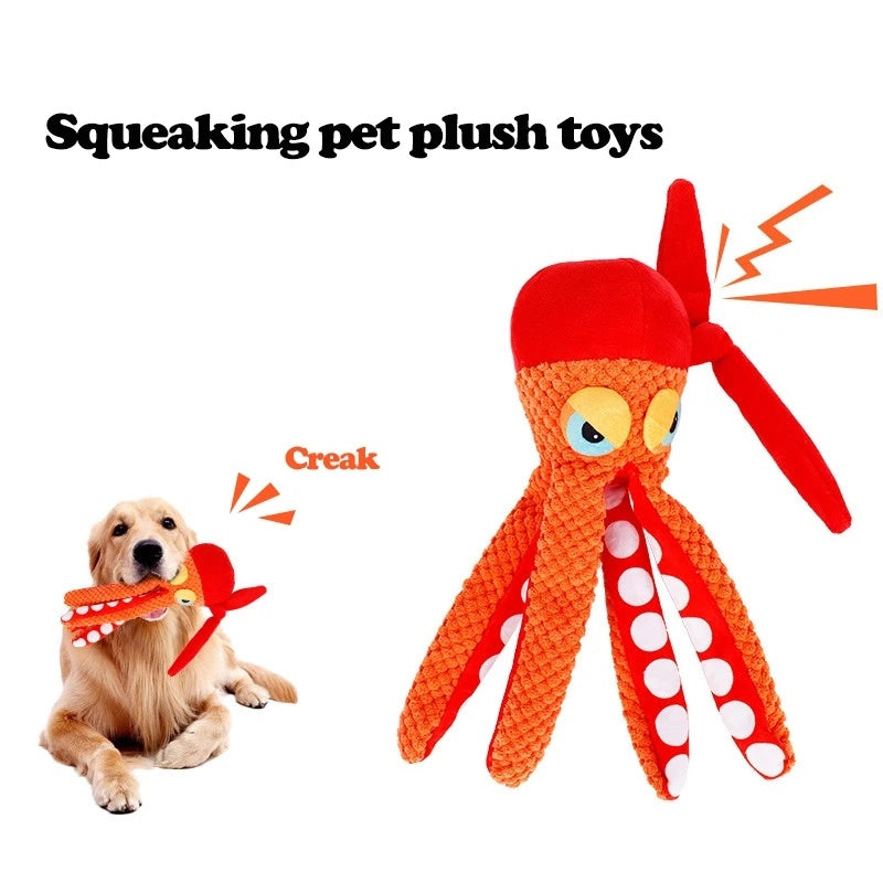 Dog playing with orange squeaking plush octopus toy