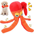 Golden retriever puppy holding orange plush octopus squeaky dog toy in mouth