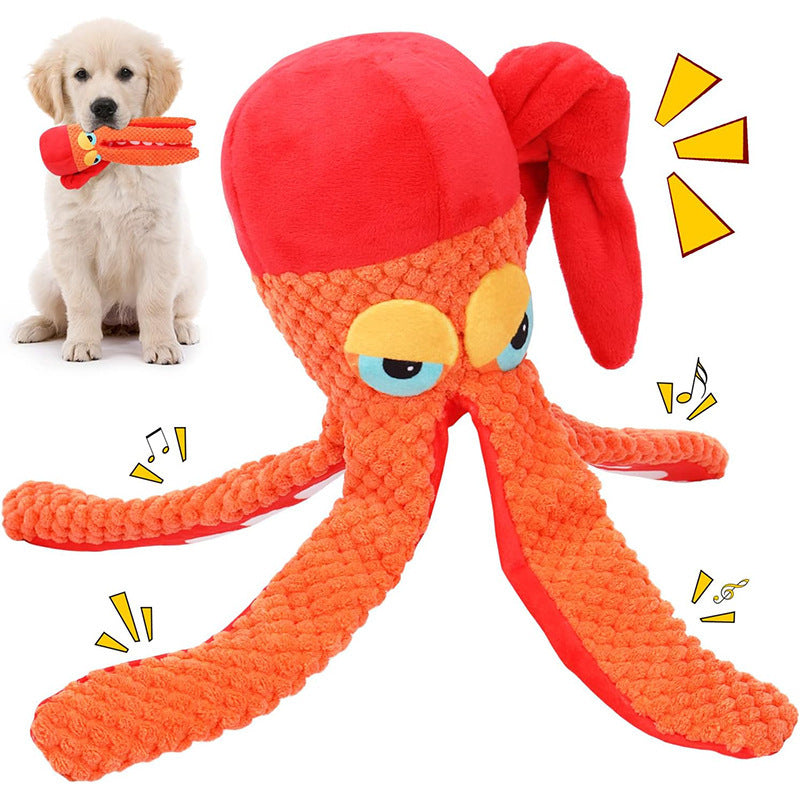 Golden retriever puppy holding orange plush octopus squeaky dog toy in mouth