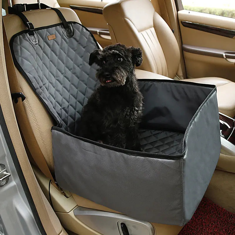 Black dog sitting in a waterproof front seat dog car seat cover with padded sides for safe and comfortable travel